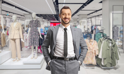 Young professional man standing in a clothing store