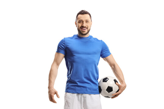 Soccer player with a ball under arm posing