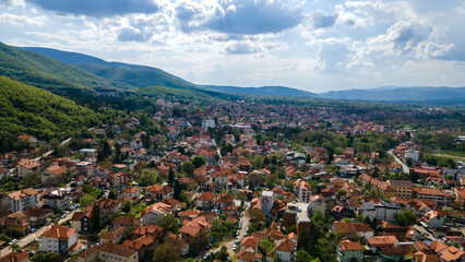 Fototapeta na wymiar Aerial view of charming small town spa Sokobanja in Serbia. Mountains with spring color trees