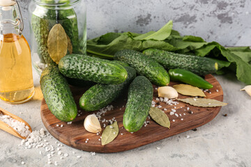 Wooden board with fresh cucumbers for preservation on table