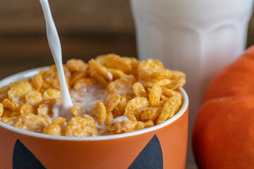 Cornflakes with milk for kid's breakfast during Halloween celebration.