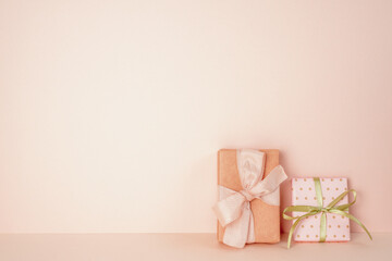 Pink gift boxes on pink table. pink wall background. copy space