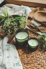 Two candles and a bouquet of lilies of the valley, spring home interior