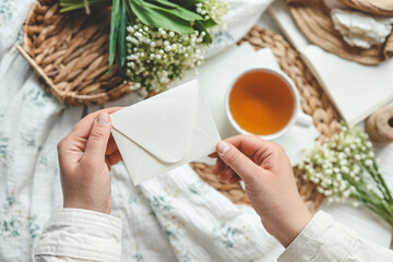 Envelope with a letter in the hands of the girl, the concept of the holiday