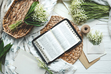 Open bible in spring interior top view, good morning concept