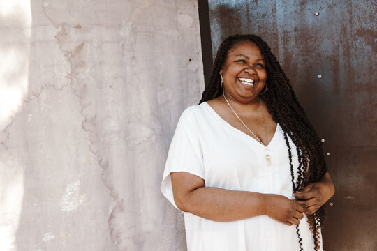 portrait of a plus size Afro Latinx Haitian American woman smiling and looking