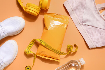 Healthy snack with sports equipment on orange background - obrazy, fototapety, plakaty