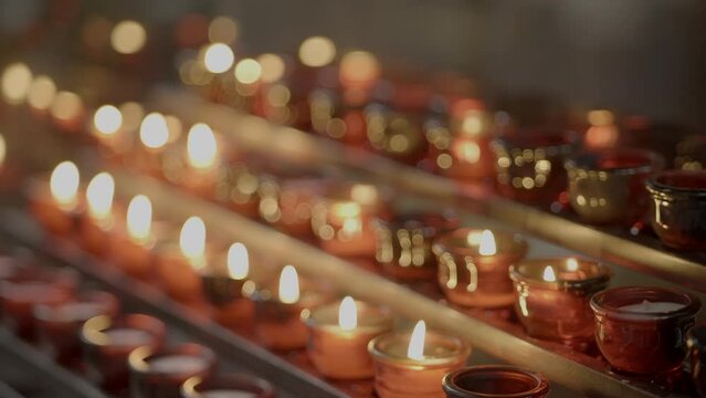 Spriritual Ceremony of Candles Lights Burning Inside Holy Church in Hope for a Better Future