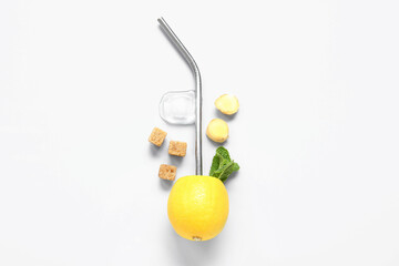 Ripe lemon with mint, ginger and straw on white background