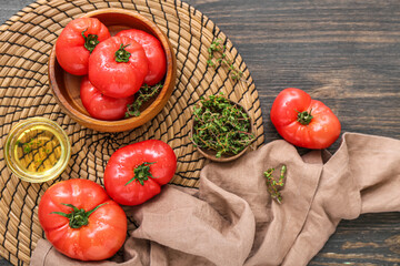 Bowl with fresh tomatoes on wooden background