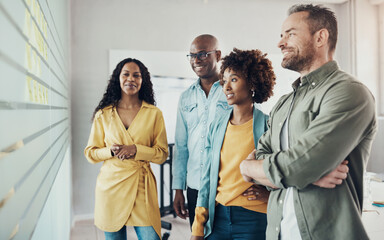 Group of diverse businesspeople smiling during an office brainstorming session