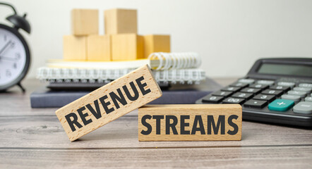 REVENUE STREAMS is shown on a conceptual photo using wooden blocks