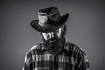 Portrait man wearing cowboy hat. Cowboys in hat. Handsome bearded macho. Man unshaven cowboys. Black and white. American cowboy. Leather Cowboy Hat