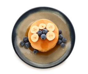 Plate with sweet pancakes, banana and blueberry on white background