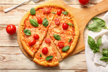Board with tasty pizza margarita on white wooden background