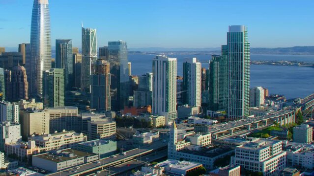 San Francisco Financial District aerial view. Famous skyscrapers. Bay bridge in the background. California, United States.  Interstate 80. Shot in 8K.