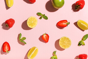 Fresh strawberries with lime and mint on pink background