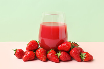Glass of tasty strawberry juice on white table