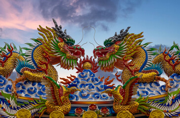 Colourful multicoloured dragon on top of a  temple in Patong Phuket Thailand. beautiful blue green...