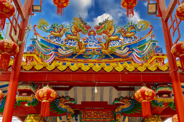 Colourful multicoloured dragon on top of a  temple in Patong Phuket Thailand. beautiful blue green red of the scale dragons