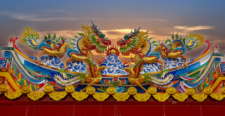 Colourful multicoloured dragon on top of a  temple in Patong Phuket Thailand. beautiful blue green red of the scale dragons
