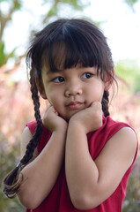 Portrait of cute little toddler girl child standing over meadow background. Close-up portrait of nice-looking lovely.