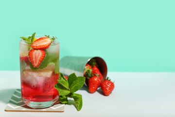 Glass of delicious strawberry mojito on color background, closeup