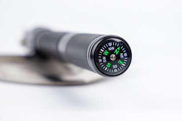 Close-up of a compass on the handle of a mining shovel. Selective focus.