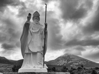 White statue of Saint Patrick at the start of foot path to the peak of Croagh Patrick, county Mayo,...