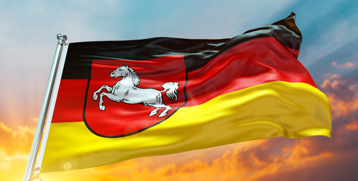 Lower Saxony Flag Waving in the Cloudy Sky at Sunset