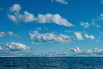 Naklejka na ściany i meble Idyllic view on Issyk-Kul lake with mountains and clouds, Kyrgyzstan