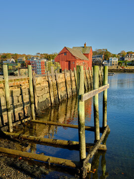 Wharf with red wooden lobster processing building in a vertical image in Rockport Massachusetts