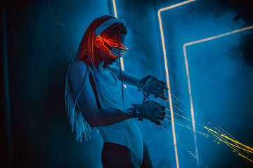 Woman dancer with lasers standing in night club interior