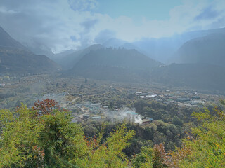 Mystical Winter Beauty: Lachung, North Sikkim, Embraced by Eastern Himalayan Mountains, Sun-Kissed Trees in Hazy Morning
