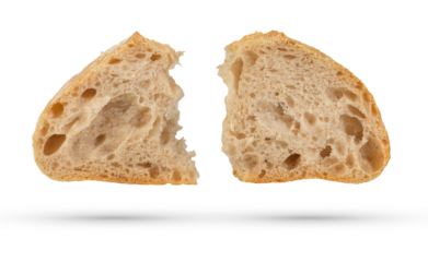 Two slices of fresh Ciabatta bread on a white isolated background. Slices hang or fall on a white background. The concept of Italian bread baking or delicious breakfast.