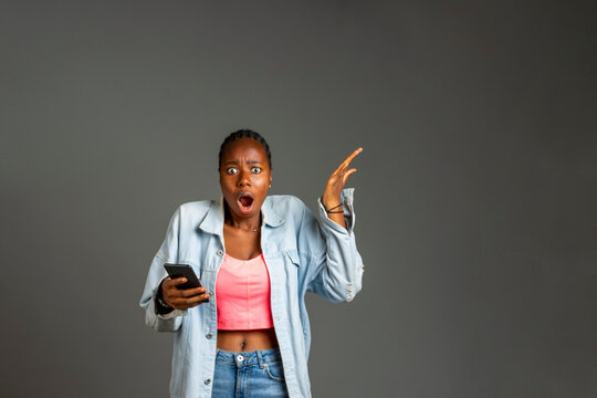 young african lady excited about what she saw in her phone