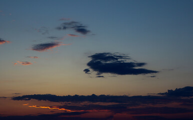 Background of the evening sky with a dark cloud on it, golden lines