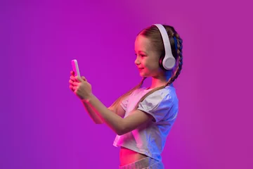 Gordijnen Happy girl have video call with friends, using headphones, phone © Prostock-studio