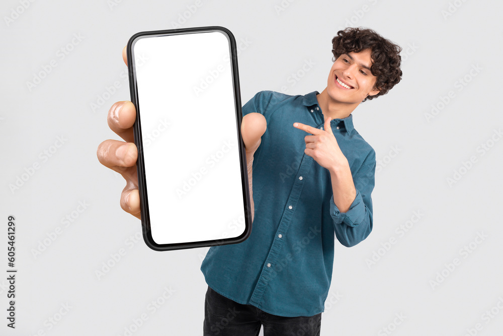 Poster man displaying oversized smartphone with blank screen over white background