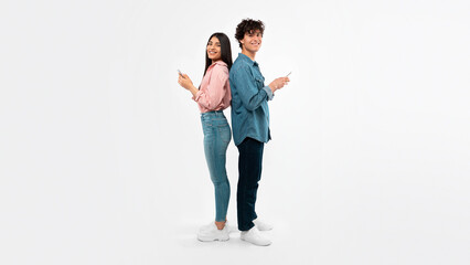 Girlfriend And Boyfriend Using Smartphones Texting Standing Over White Background