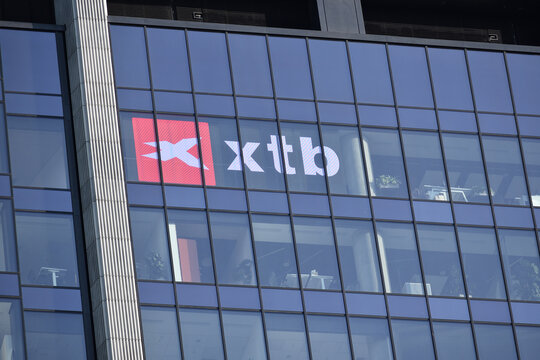 XTB company logo, signage, emblem on the facade. Polish trading platform, online broker, global leader in FX and CFD trading. WARSAW, POLAND - MAY 21, 2023