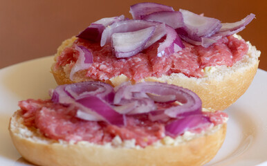 Two half-mead rolls with red onions, closeup