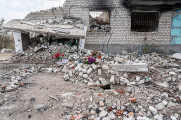 IZYUM, UKRAINE - April 8, 2023: Photos of the civilians, commemorative candles and flowers at the...