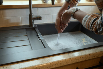 Overflowing kitchen sink, clogged drain.