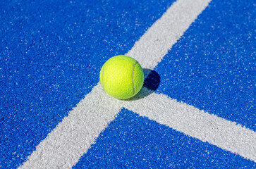 ball on a blue paddle tennis court line