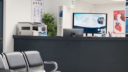 Empty reception desk at medical facility, waiting area with chairs in health center. Hospital lobby seats at private clinic used for recovery service, checkup examination with medical assistance.