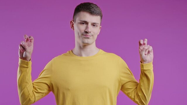  Young teenage guy showing two fingers air quotes gesture. Not funny, irony