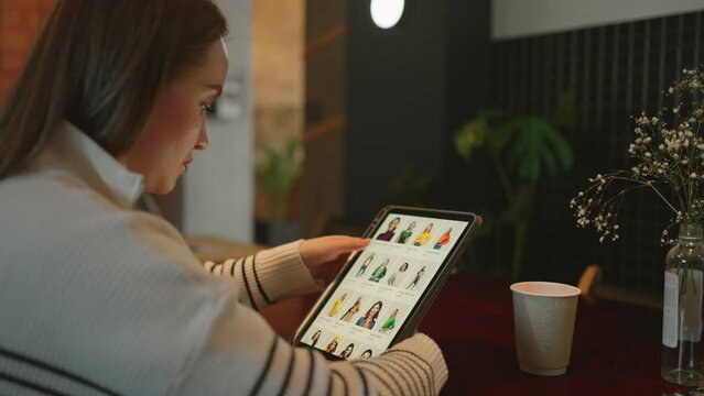Efficient Shopping: Woman Uses Tablet to Find and Buy Clothing