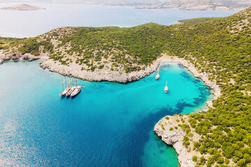 Aerial shot with yachts resting in beautiful Akvaryum koyu in Bodrum, Turkey - obrazy, fototapety, plakaty