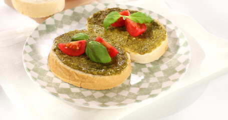 pesto sauce on bread. traditional italian green sauce. angle view. sunny day.